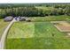 View of the horse barn, silos, outbuildings and pasture on a large well-kept lot at 5187 Parkview Rd, Social Circle, GA 30025