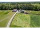 View of the horse barn, silos, outbuildings and pasture on a well maintained lot at 5187 Parkview Rd, Social Circle, GA 30025