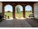 Covered patio featuring stone archways and comfortable rocking chair at 5187 Parkview Rd, Social Circle, GA 30025