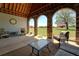 Covered patio offers comfortable seating and beautiful views of manicured lawn at 5187 Parkview Rd, Social Circle, GA 30025