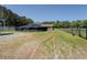 Large land area with a barn, black shade structure, and fencing dividing the grassy areas at 5187 Parkview Rd, Social Circle, GA 30025