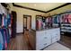 Large walk-in closet offers ample storage, custom shelving and an island with granite countertop at 5187 Parkview Rd, Social Circle, GA 30025