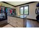 Spacious walk-in closet with storage island, custom shelving, and natural light at 5187 Parkview Rd, Social Circle, GA 30025