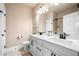 Elegant bathroom featuring double sinks, white cabinetry, dark hardware, and a shower with glass door at 530 Payne Rd, Woodstock, GA 30188