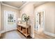 Welcoming entryway with a console table, mirror, and access to a bathroom with tile floors at 530 Payne Rd, Woodstock, GA 30188