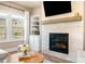 Close up of fireplace with a stone surround, wooden beam mantel, and built-in shelving at 530 Payne Rd, Woodstock, GA 30188