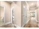Bright hallway with wood floors, white trim and views to bathroom, laundry and living spaces at 530 Payne Rd, Woodstock, GA 30188