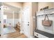 Inviting hallway with access to playroom, featuring a hall tree and wood flooring throughout at 530 Payne Rd, Woodstock, GA 30188