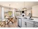 Bright, open kitchen with island sink, dining area, and view into the living room at 530 Payne Rd, Woodstock, GA 30188
