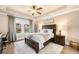 Serene main bedroom with tray ceilings, large window, and modern furnishings at 530 Payne Rd, Woodstock, GA 30188