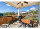 Covered patio area with outdoor seating, a grill, and views of the landscaped backyard at 530 Payne Rd, Woodstock, GA 30188