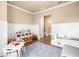 Spacious playroom featuring storage shelves, table, chairs, a toy kitchen, and a comfortable sofa at 530 Payne Rd, Woodstock, GA 30188