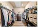 Organized walk-in closet with shelves and drawers for storage and a center dresser at 530 Payne Rd, Woodstock, GA 30188