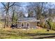 Wide angle shot of a spacious backyard with stone patio dining and lounge areas at 1045 Moreland Se Ave, Atlanta, GA 30316
