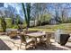 Backyard patio with a stone retaining wall, furnished dining set, and a separate seating area at 1045 Moreland Se Ave, Atlanta, GA 30316