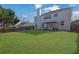Expansive backyard featuring a lush green lawn, a patio area, and a wooden fence at 3184 Elmwood Ct, Atlanta, GA 30349