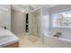 Bright bathroom featuring a soaking tub, separate shower, double vanity, and lots of natural light at 3184 Elmwood Ct, Atlanta, GA 30349