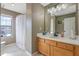 This bathroom features a vanity with a large mirror and a shower with a curtain at 3184 Elmwood Ct, Atlanta, GA 30349