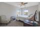 The bedroom includes a ceiling fan, a large window, carpeted floors, and an accent chair at 3184 Elmwood Ct, Atlanta, GA 30349