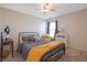 This bedroom features neutral walls, a ceiling fan, and a window providing natural light at 3184 Elmwood Ct, Atlanta, GA 30349