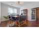 Elegant dining room with hardwood floors, a modern light fixture, and a wooden table with upholstered chairs at 3184 Elmwood Ct, Atlanta, GA 30349