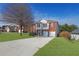 Attractive two-story brick house with a spacious front yard and a long driveway leading to the garage at 3184 Elmwood Ct, Atlanta, GA 30349