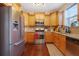 Well-equipped kitchen with stainless steel appliances, wood cabinets, and hardwood floors, creating a functional space at 3184 Elmwood Ct, Atlanta, GA 30349