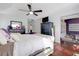 The bright main bedroom features hardwood floors, a ceiling fan, and an attached office space at 3184 Elmwood Ct, Atlanta, GA 30349
