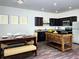Eat-in kitchen boasts dark wood cabinets, an island, stainless appliances, and stylish flooring at 3333 Tarian Way, Decatur, GA 30034