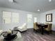 Open-plan living and dining area with bright neutral walls, hardwood floors, and ample natural light at 3333 Tarian Way, Decatur, GA 30034