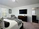 Spacious bedroom featuring a mounted TV, chair, dresser, and ensuite bath with dark wood flooring at 3333 Tarian Way, Decatur, GA 30034