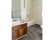 Bathroom featuring a tub/shower, sink and vanity with wood laminate floors at 3628 Hopkins Ct, Powder Springs, GA 30127