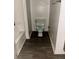 A bathroom with a toilet, bathtub, and wood laminate floors at 3628 Hopkins Ct, Powder Springs, GA 30127