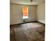 This is a bedroom with a window, stained walls and carpet at 3628 Hopkins Ct, Powder Springs, GA 30127
