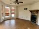 Living room featuring wood floors, a fireplace with stone accents, and large windows at 3628 Hopkins Ct, Powder Springs, GA 30127