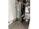 Utility room featuring a furnace, water heater, and vinyl flooring at 3628 Hopkins Ct, Powder Springs, GA 30127