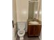Compact bathroom with a traditional toilet, vanity sink, and mirror, offering functionality and simple design at 3634 Hopkins Ct, Powder Springs, GA 30127