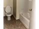 Modest bathroom featuring a standard toilet and a white bathtub with a shower at 3634 Hopkins Ct, Powder Springs, GA 30127