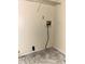 Compact laundry area featuring a washing machine hookup, electrical outlet, and metal shelving for storage solutions at 3634 Hopkins Ct, Powder Springs, GA 30127