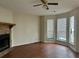 Bright living room featuring hardwood floors, a cozy fireplace, and large windows with ample natural light at 3634 Hopkins Ct, Powder Springs, GA 30127