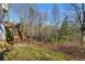 The backyard shows a stairwell leading to the upper deck and a wooded view at 674 Fairview Dr, Dallas, GA 30157