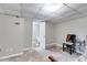 Unfinished basement bedroom with neutral walls, a small chair, and visible bathroom through an open doorway at 674 Fairview Dr, Dallas, GA 30157