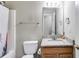Bathroom featuring a toilet, granite countertop vanity, and a shower-tub with a white curtain at 674 Fairview Dr, Dallas, GA 30157