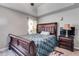 Well-lit bedroom with wood-framed bed, classic furniture, neutral walls, and bright sunflower print curtains at 674 Fairview Dr, Dallas, GA 30157