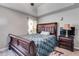Bedroom featuring ceiling fan, wood trim, decorative bed frame, and a plaid bedspread at 674 Fairview Dr, Dallas, GA 30157