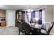 Elegant dining room featuring a large table, chairs, hutch, and window with violet patterned sheer curtains at 674 Fairview Dr, Dallas, GA 30157