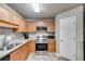 Well-equipped kitchen with stainless steel appliances, wood cabinets, granite counters, and modern fixtures at 674 Fairview Dr, Dallas, GA 30157