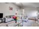 Bright living room with comfortable seating, glass coffee table, and staircase in the background at 674 Fairview Dr, Dallas, GA 30157