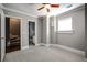 Neutral bedroom featuring carpet, a window, and two doors. The room also has decorative crown molding at 7 Chief Matthews Rd # 2A, Decatur, GA 30030