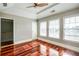 Bedroom with wooden floors and large windows, adjacent to a stairwell at 7 Chief Matthews Rd # 2A, Decatur, GA 30030